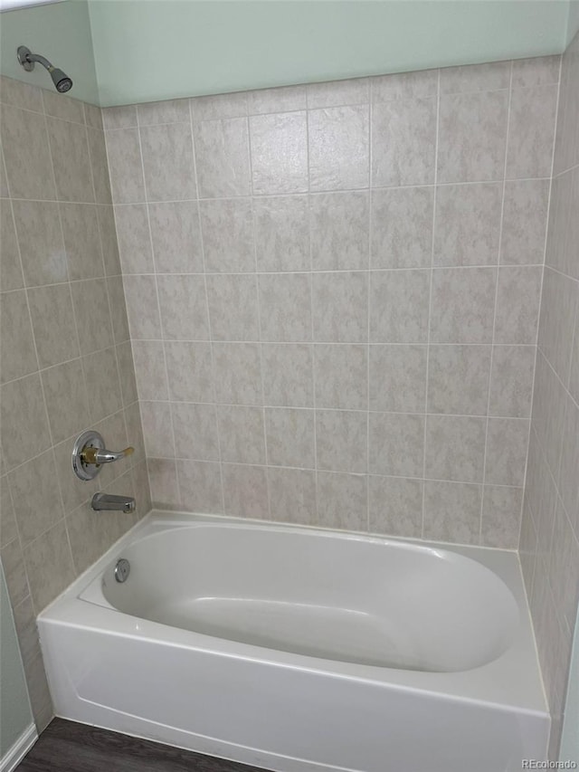 bathroom featuring wood finished floors and shower / tub combination