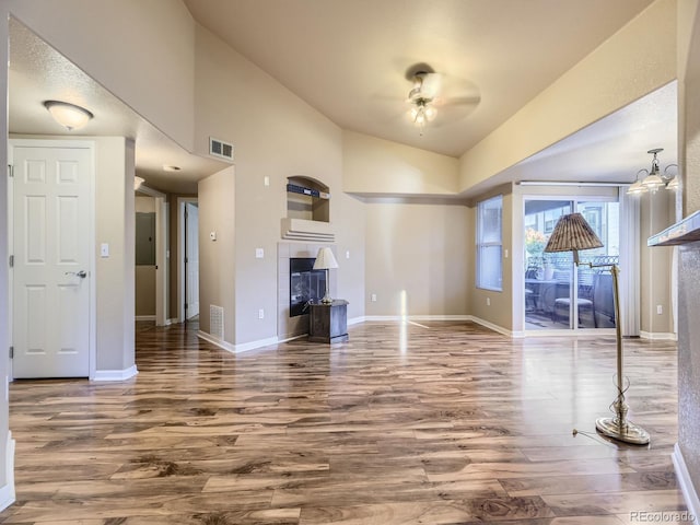 unfurnished living room featuring lofted ceiling and hardwood / wood-style flooring