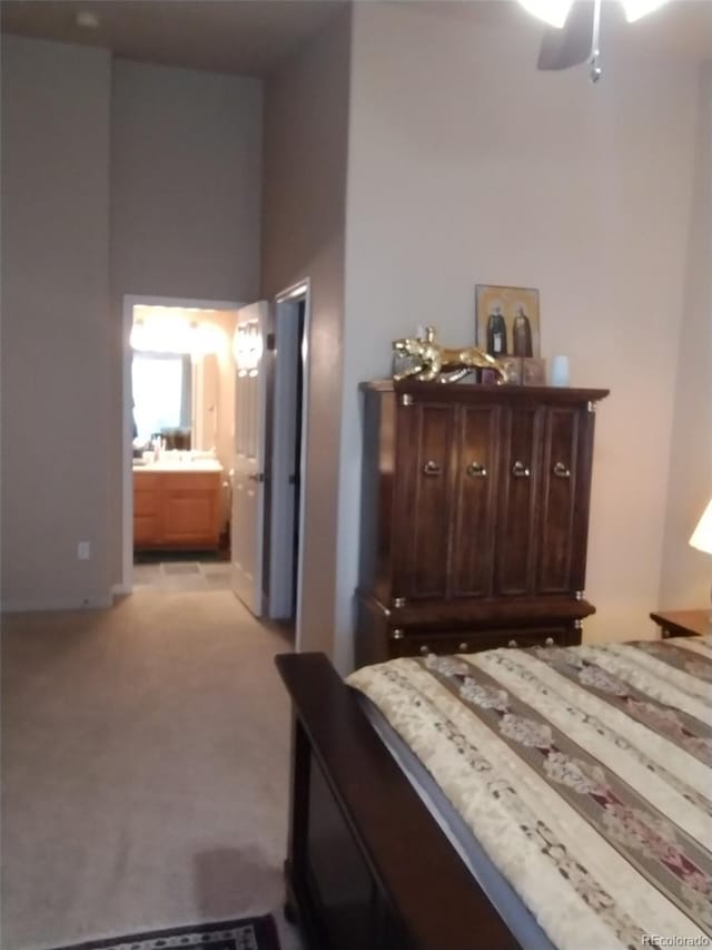 bedroom featuring light carpet and ensuite bath