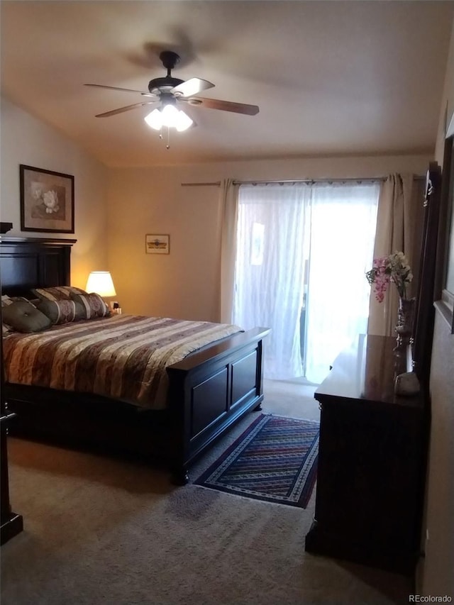 carpeted bedroom featuring lofted ceiling and ceiling fan