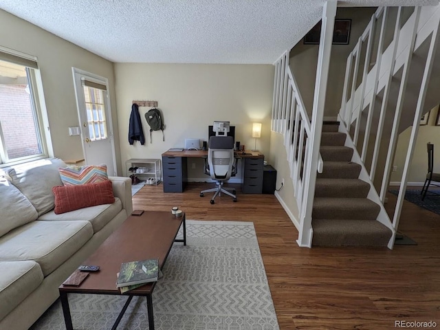home office with baseboards, a textured ceiling, and wood finished floors