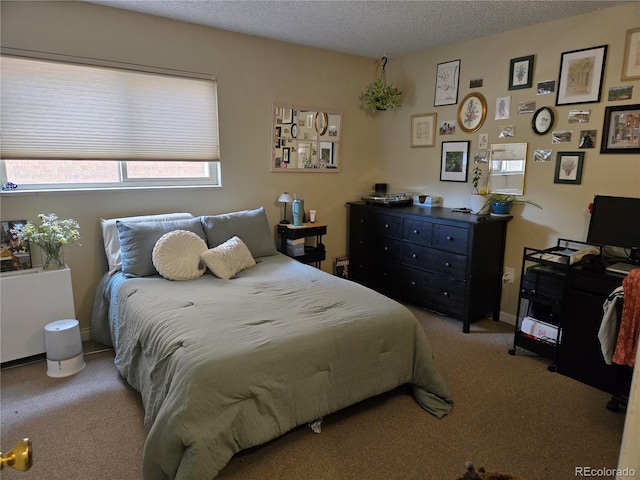 bedroom featuring carpet floors and a textured ceiling