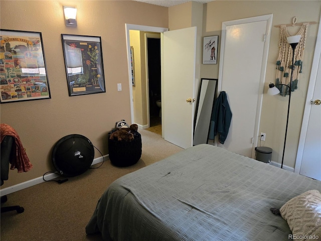 bedroom with baseboards and carpet