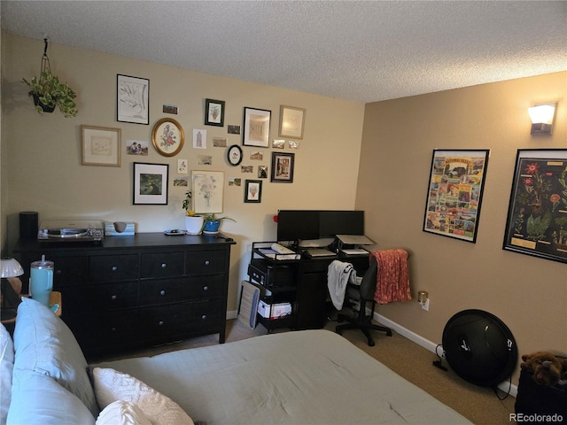carpeted bedroom with baseboards and a textured ceiling