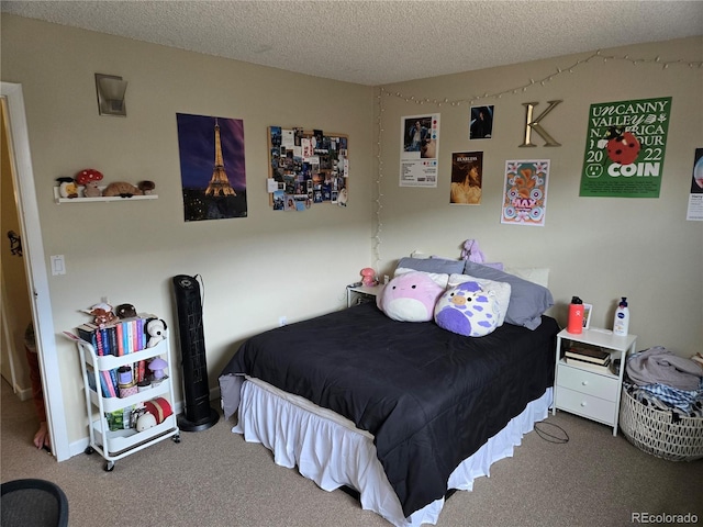 carpeted bedroom featuring a textured ceiling