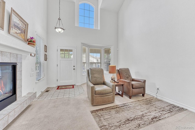 8943 Tappy Toorie Cir, Highlands Ranch, CO 80129 - entryway with carpet floors, a fireplace, baseboards, plenty of natural light, and a towering ceiling
