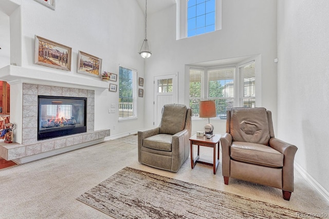 8943 Tappy Toorie Cir, Highlands Ranch, CO 80129 - sitting room featuring carpet, healthy amount of natural light, baseboards, a tiled fireplace, and a high ceiling