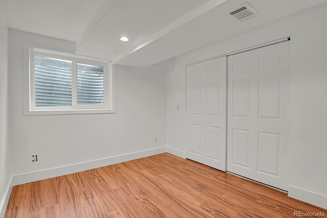 unfurnished bedroom featuring visible vents, baseboards, a closet, light wood finished floors, and recessed lighting