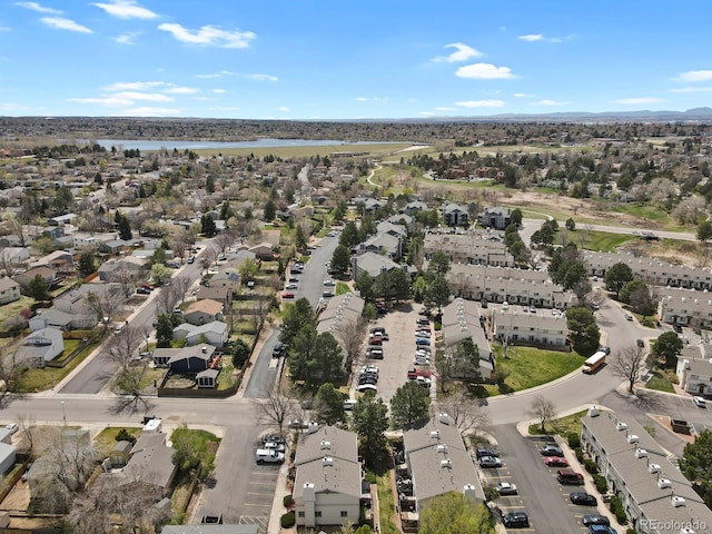 drone / aerial view with a water view and a residential view