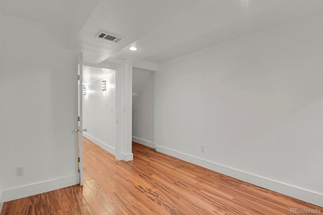 unfurnished room featuring recessed lighting, baseboards, light wood-type flooring, and visible vents