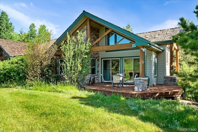 378 Fox Acres Dr W, Red Feather Lakes, CO 80545 - back of property with stone siding, a yard, and a wooden deck