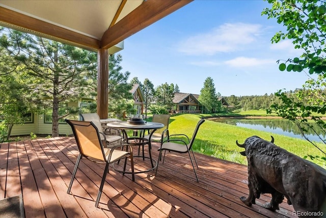 378 Fox Acres Dr W, Red Feather Lakes, CO 80545 - wooden terrace featuring a water view, a lawn, and outdoor dining area