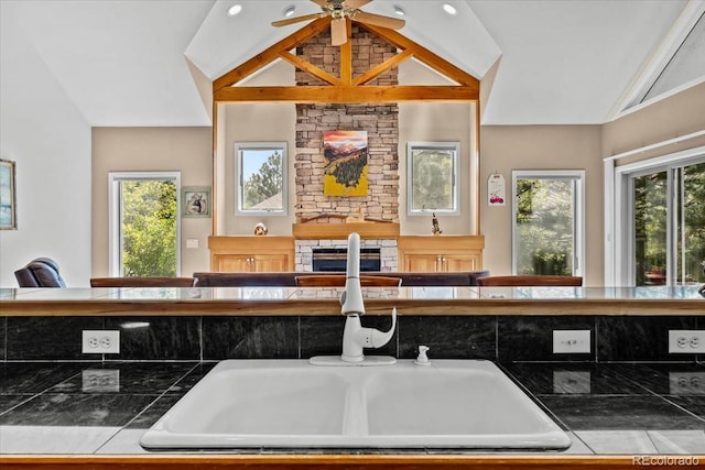378 Fox Acres Dr W, Red Feather Lakes, CO 80545 - kitchen with vaulted ceiling, tile counters, ceiling fan, and open floor plan