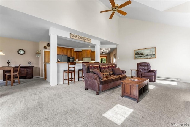 378 Fox Acres Dr W, Red Feather Lakes, CO 80545 - living room featuring light colored carpet, a baseboard heating unit, ceiling fan, and vaulted ceiling