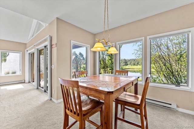 378 Fox Acres Dr W, Red Feather Lakes, CO 80545 - dining space featuring a baseboard heating unit, light colored carpet, and healthy amount of natural light
