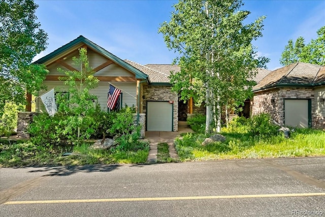 378 Fox Acres Dr W, Red Feather Lakes, CO 80545 - view of front of home with stone siding and a garage