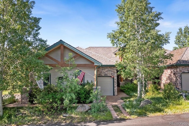 378 Fox Acres Dr W, Red Feather Lakes, CO 80545 - obstructed view of property with an attached garage and stone siding