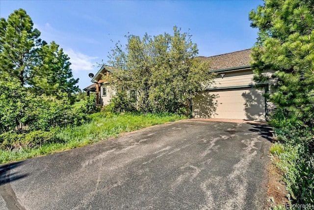 378 Fox Acres Dr W, Red Feather Lakes, CO 80545 - obstructed view of property with driveway and an attached garage