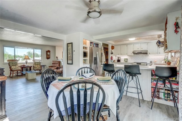 dining room featuring ceiling fan and light hardwood / wood-style floors