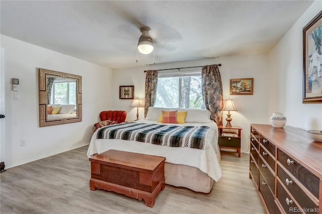 bedroom with ceiling fan and light wood-type flooring