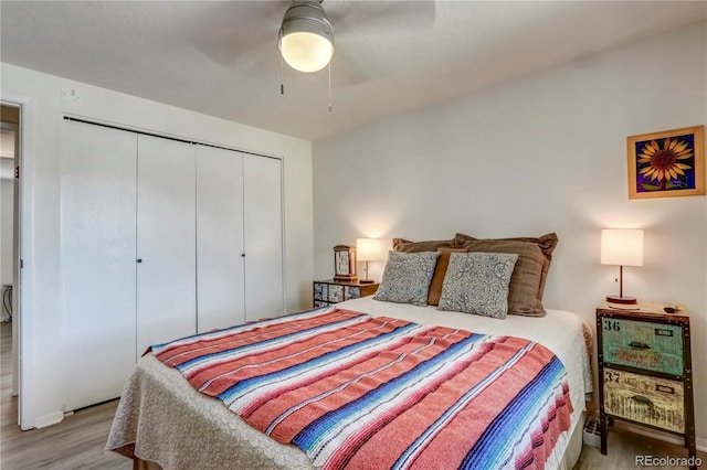 bedroom featuring hardwood / wood-style floors, a closet, and ceiling fan