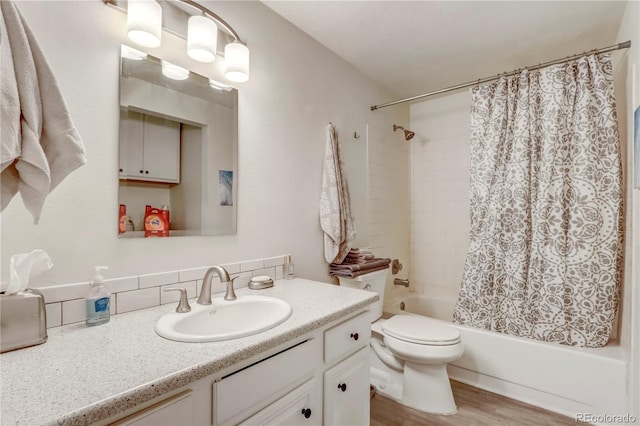 full bathroom with vanity with extensive cabinet space, wood-type flooring, shower / tub combo with curtain, backsplash, and toilet