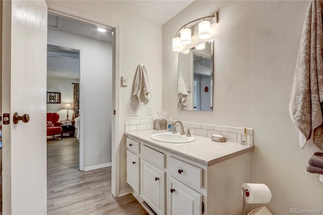 bathroom featuring hardwood / wood-style floors and oversized vanity