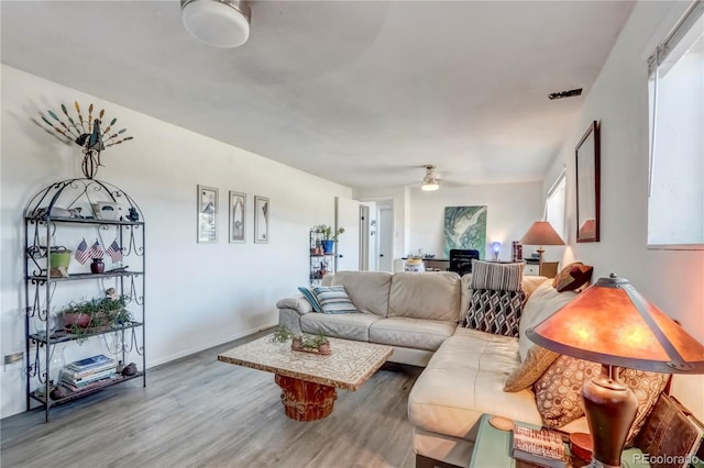 living room featuring hardwood / wood-style floors and ceiling fan