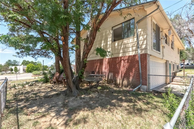 112 Main St, Walsenburg, CO 81089 - view of property exterior with an attached garage and brick siding