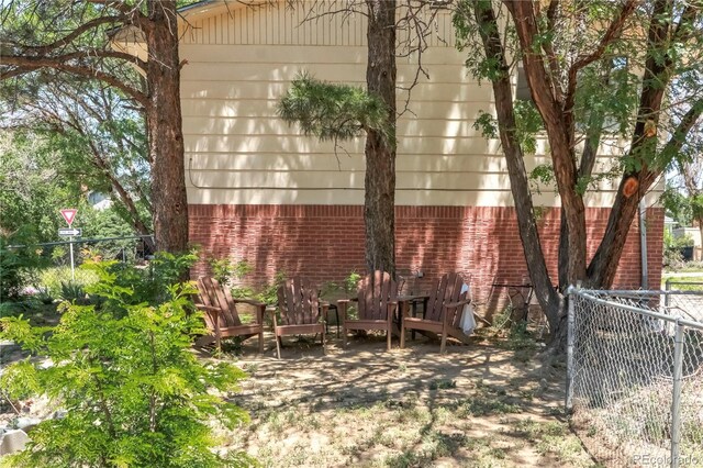 112 Main St, Walsenburg, CO 81089 - view of home's exterior with fence and brick siding