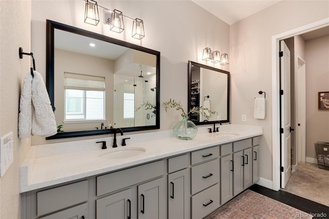 bathroom with vanity, a shower with door, and tile patterned floors