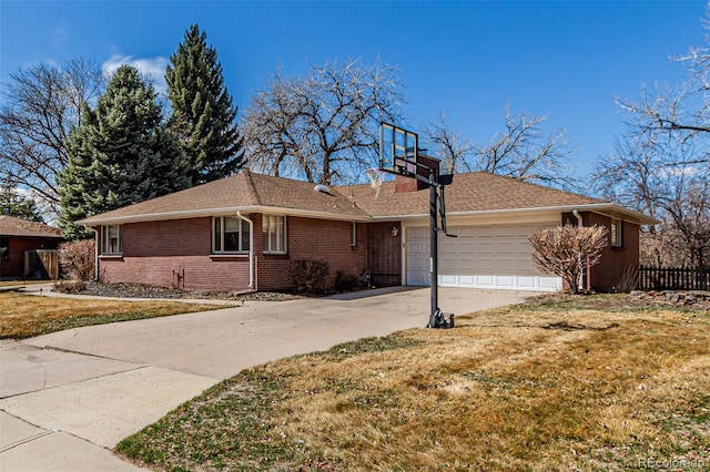 single story home with brick siding, an attached garage, a front lawn, a chimney, and driveway