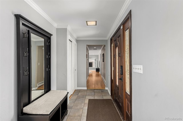 hallway with light tile patterned floors, a baseboard heating unit, baseboards, and ornamental molding