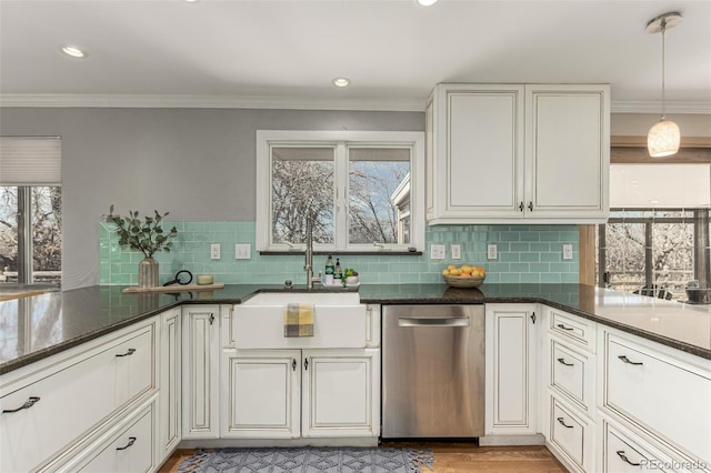 kitchen featuring tasteful backsplash, dishwasher, ornamental molding, and white cabinetry