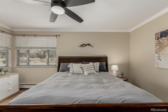 bedroom with a baseboard heating unit, crown molding, wood finished floors, and a ceiling fan