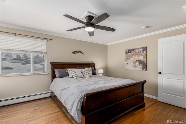 bedroom featuring crown molding, light wood-type flooring, and baseboard heating