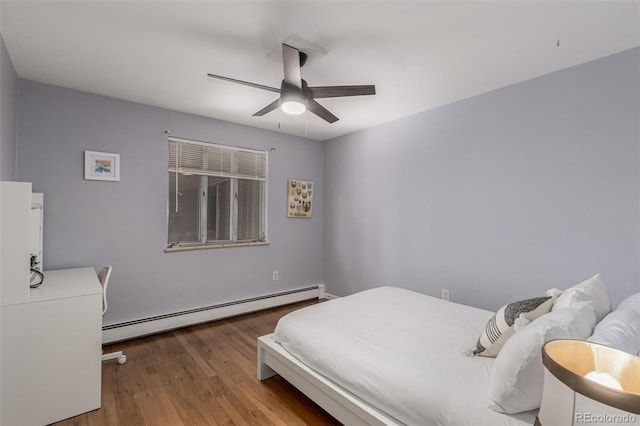 bedroom featuring a baseboard heating unit, ceiling fan, and wood finished floors