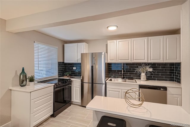 kitchen with decorative backsplash, sink, white cabinets, and stainless steel appliances