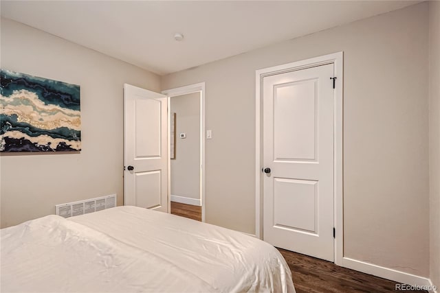 bedroom featuring dark wood-type flooring