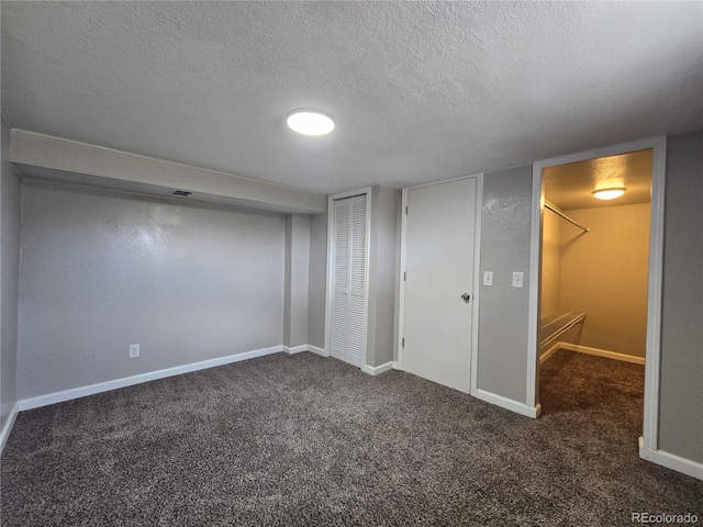 2865 Carnation Way, Thornton, CO 80229 - unfurnished bedroom featuring a textured ceiling, carpet, and a closet