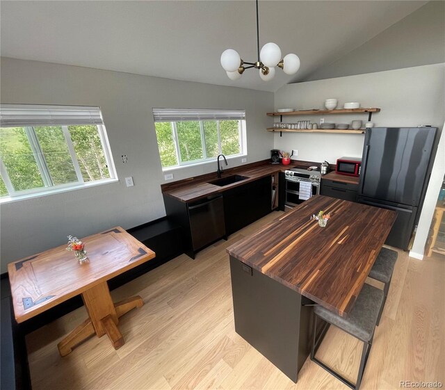 69 Noxibee Ct, Como, CO 80432 - kitchen with black appliances, butcher block countertops, lofted ceiling, light wood finished floors, and open shelves