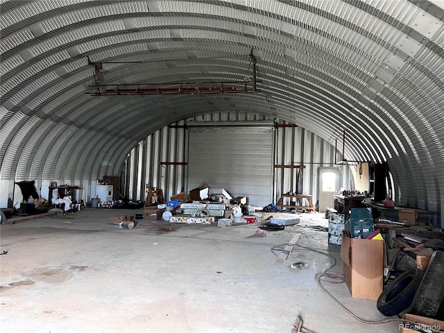 misc room featuring concrete flooring and vaulted ceiling