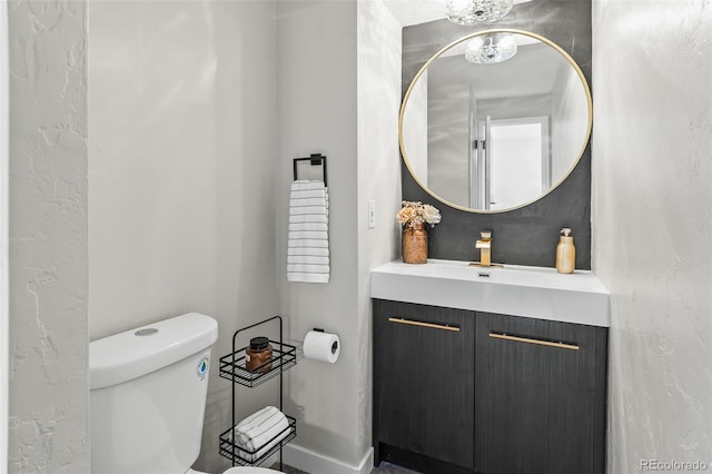 bathroom featuring toilet and vanity