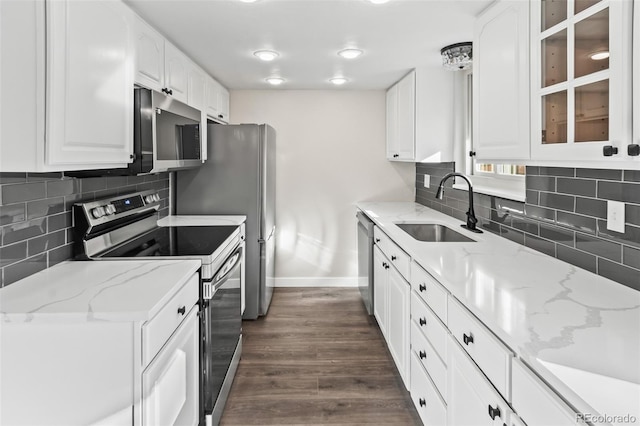 kitchen featuring stainless steel appliances, dark hardwood / wood-style floors, white cabinets, light stone counters, and sink