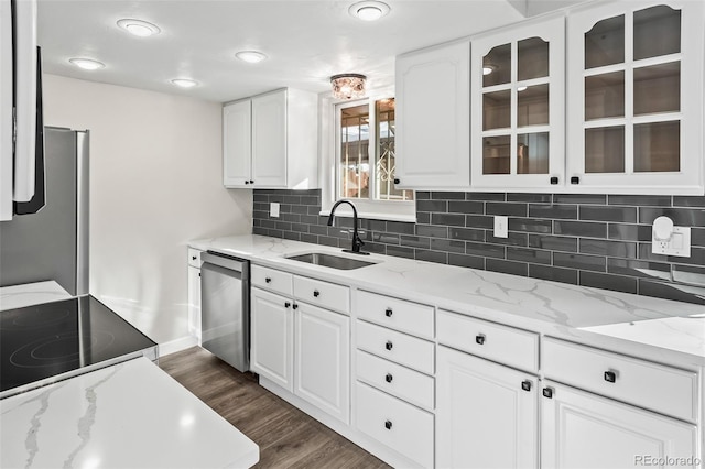 kitchen featuring stainless steel appliances, sink, white cabinetry, and light stone countertops