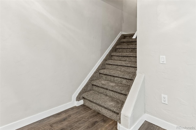 stairway with hardwood / wood-style floors