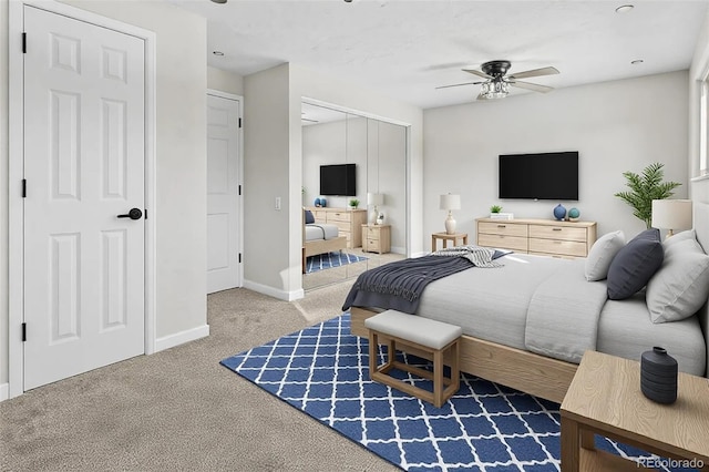 bedroom featuring ensuite bathroom, ceiling fan, carpet flooring, and a closet