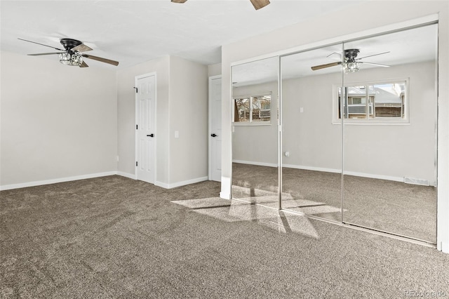 carpeted spare room featuring ceiling fan