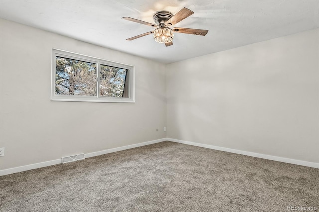 spare room featuring ceiling fan and carpet flooring