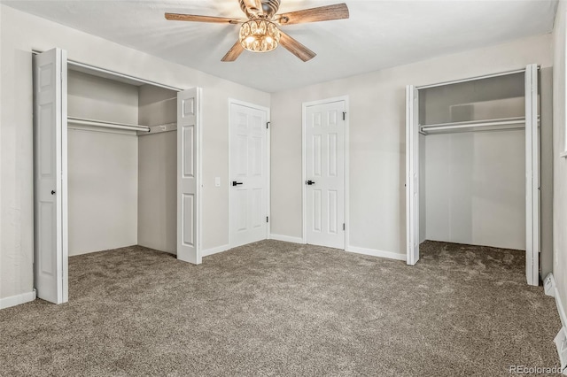 unfurnished bedroom with ceiling fan, two closets, and carpet floors